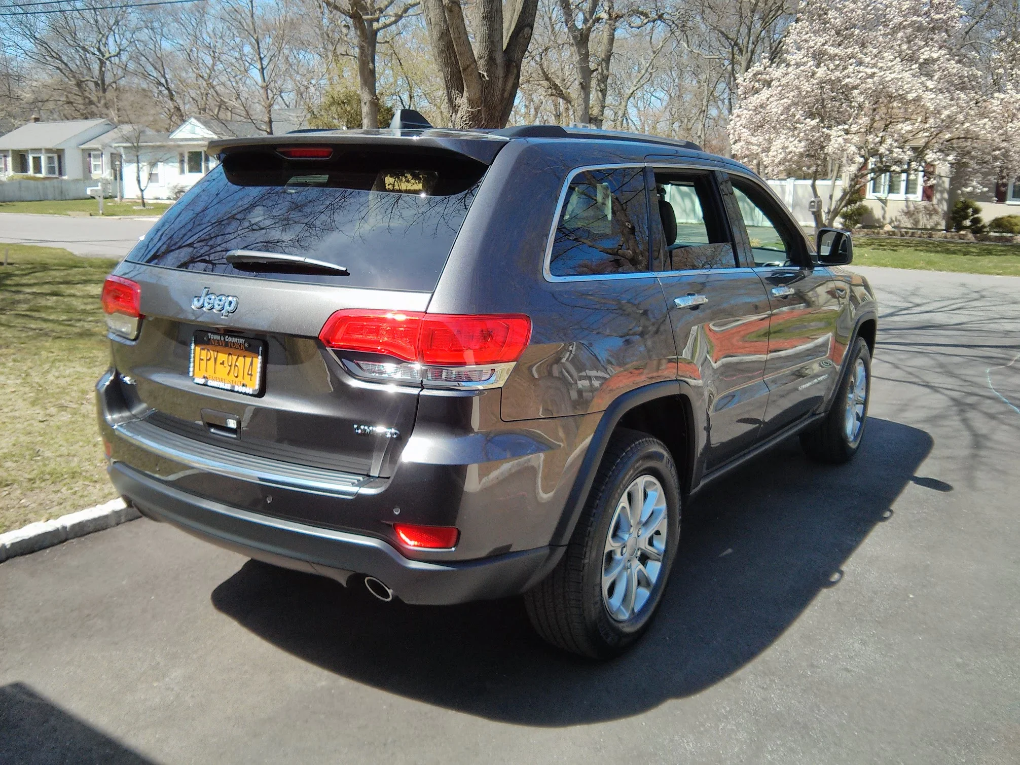Jeep Grand Cherokee in granite crystal metallic, rear three-quarter view