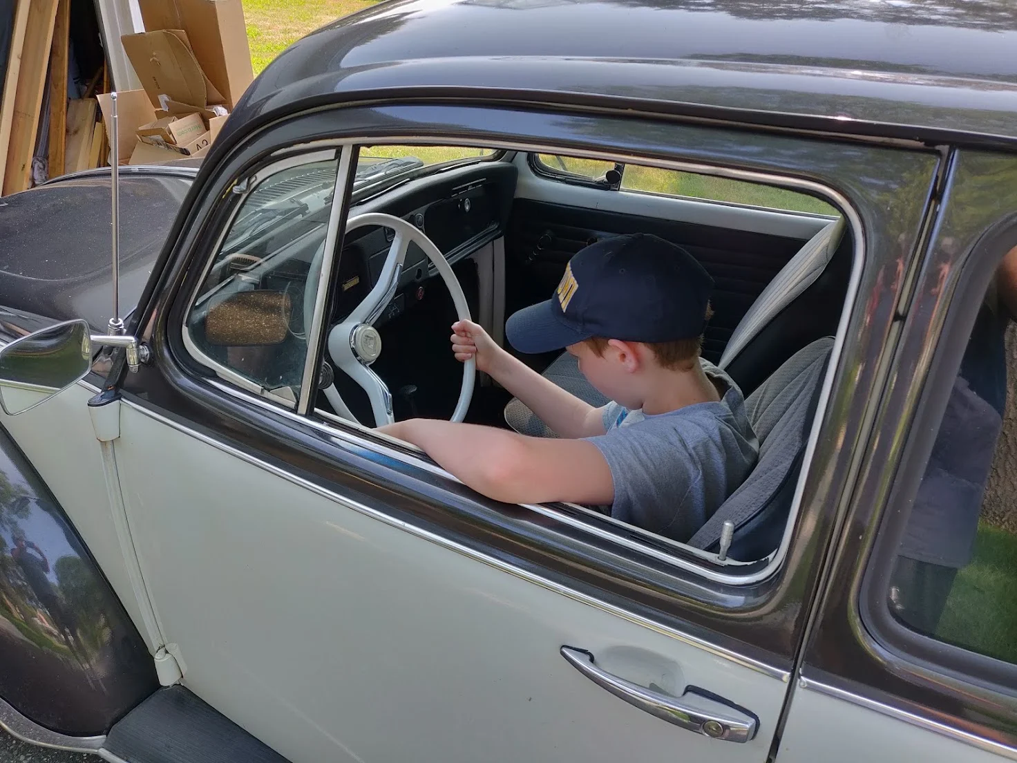 Son behind the wheel of the VW Beetle project car