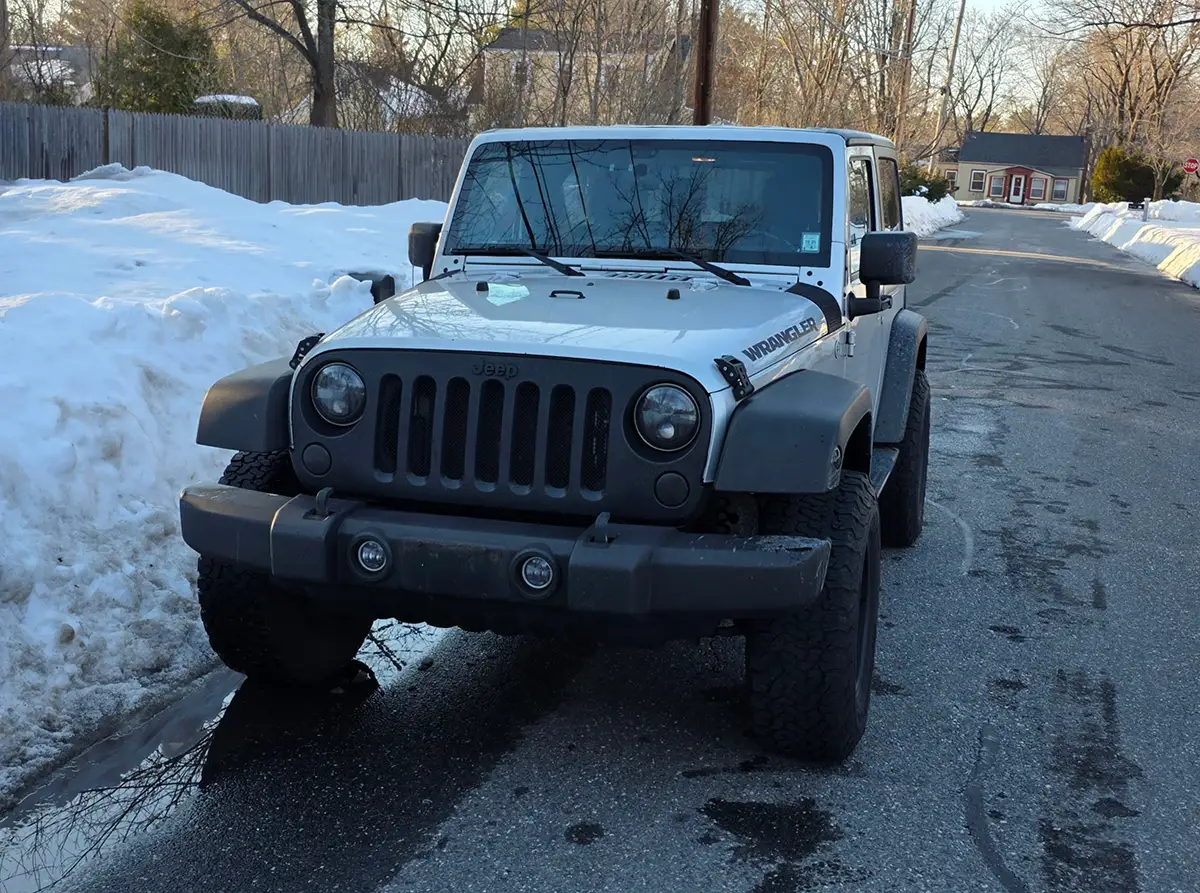 JK Wrangler parked on a snowy street, ready for its last trip