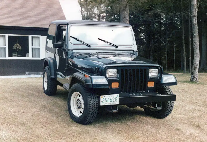 1987 Jeep Wrangler YJ parked by the garage